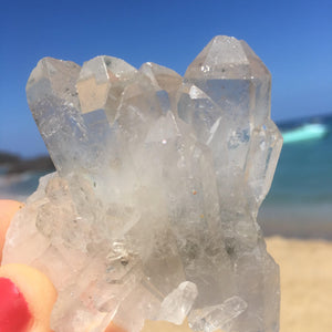 clear quartz cluster on the beach